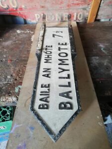 Ballymote / Baile an Mhóte bilingual road sign before restoration at Sligo Folk Park